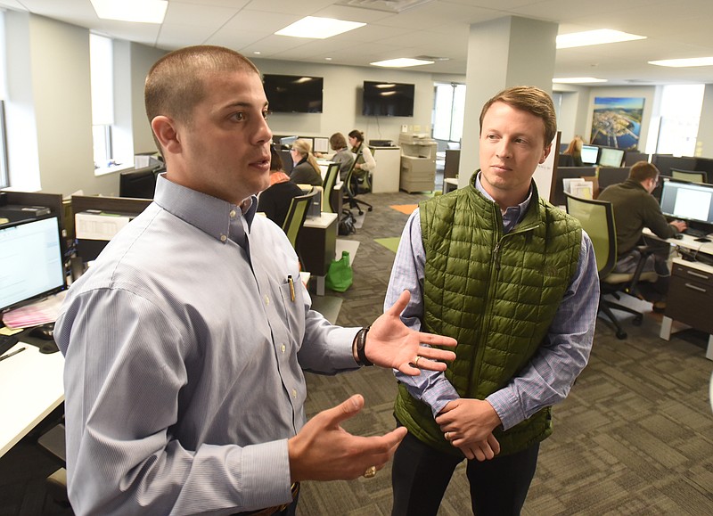 Jack Silberman, left, and Ryan Davis talk in the Reliance HR Management offcies on Georgia Avenue.