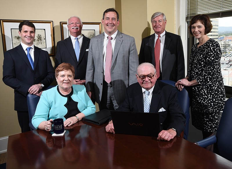 Daniel Carter, center, President at The Trust Company, stands with his team, seated from left, Deborah F. Miller and W. Fred Speakman Jr. Standing from left, William M. Walker IV, Andrew J Muldoon, III, Carter, James A. Woods and Stacy Roettger.