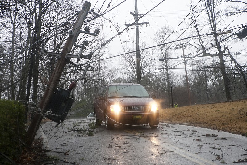 Signal Mountain was not immune to the outbreak of tornadoes across the area in 2011. Thunderstorms and tornadoes downed at least 75 trees across mountain roads. Shown here is the top of a telephone pole, with wires and transformer attached, that was snapped off and left dangling across a road in Signal Mountain.