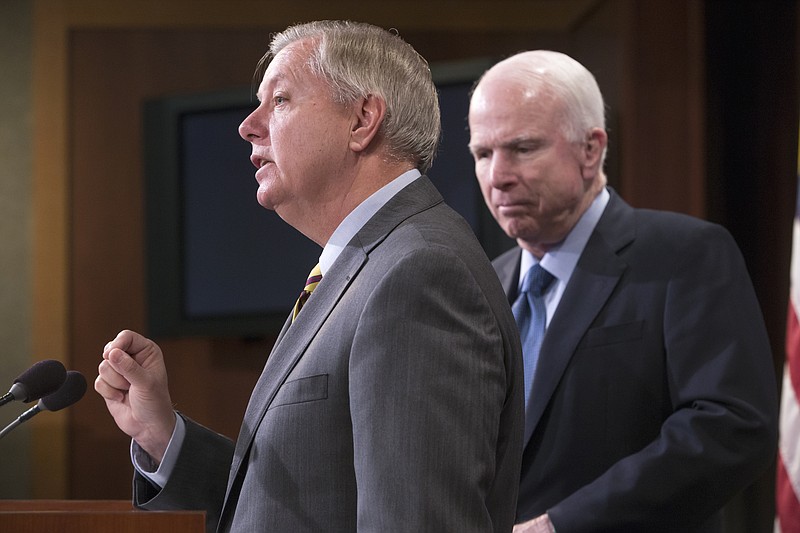 
              FILE - In this Feb. 24, 2016, file photo, Republican members of the Senate Armed Services Committee, Sen. Lindsey Graham, R-S.C., center, and committee chairman John McCain, R-Ariz., speak at a news conference on Capitol Hill in Washington. Graham and McCain are assembling a harsh critique of Donald Trump’s worldview by soliciting rebuttals from U.S. military leaders that challenge the accuracy and legality of his most provocative foreign policy positions. (AP Photo/J. Scott Applewhite, File)
            