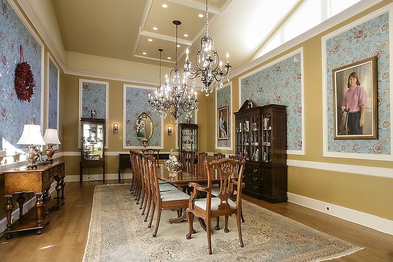 A beautiful formal dining room is decorated with family heirlooms. 