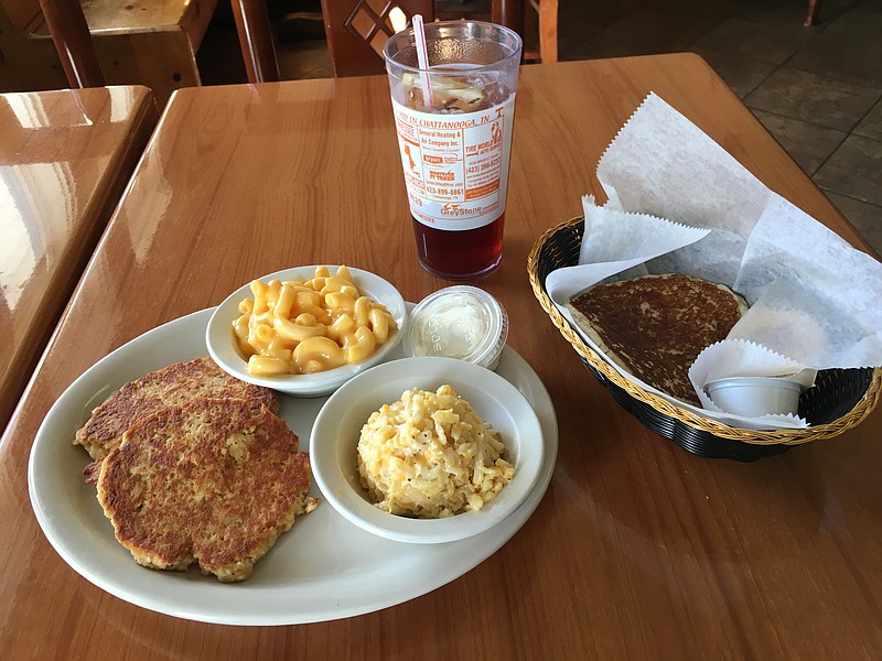 Salmon patties, a recent daily special, are served with mac-and-cheese and hash brown casserole, two of 23 sides offered at Lillie Mae's Place in Red Bank. A basket of fried cornbread and a glass of sweet tea complete the meal.