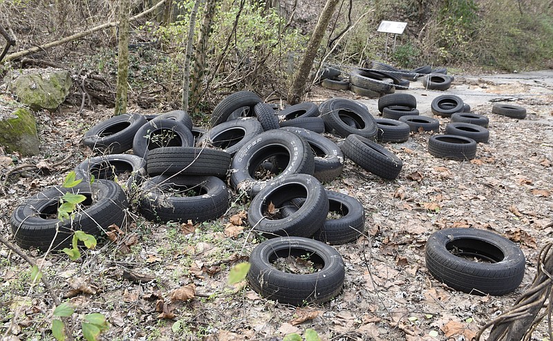 Tires are seen dumped along an Old Wauhatchie Pike trail near a historical marker on Cummings Highway at the foot of Lookout Mountain on Thursday, Jan. 7, 2016, in Chattanooga, Tenn.