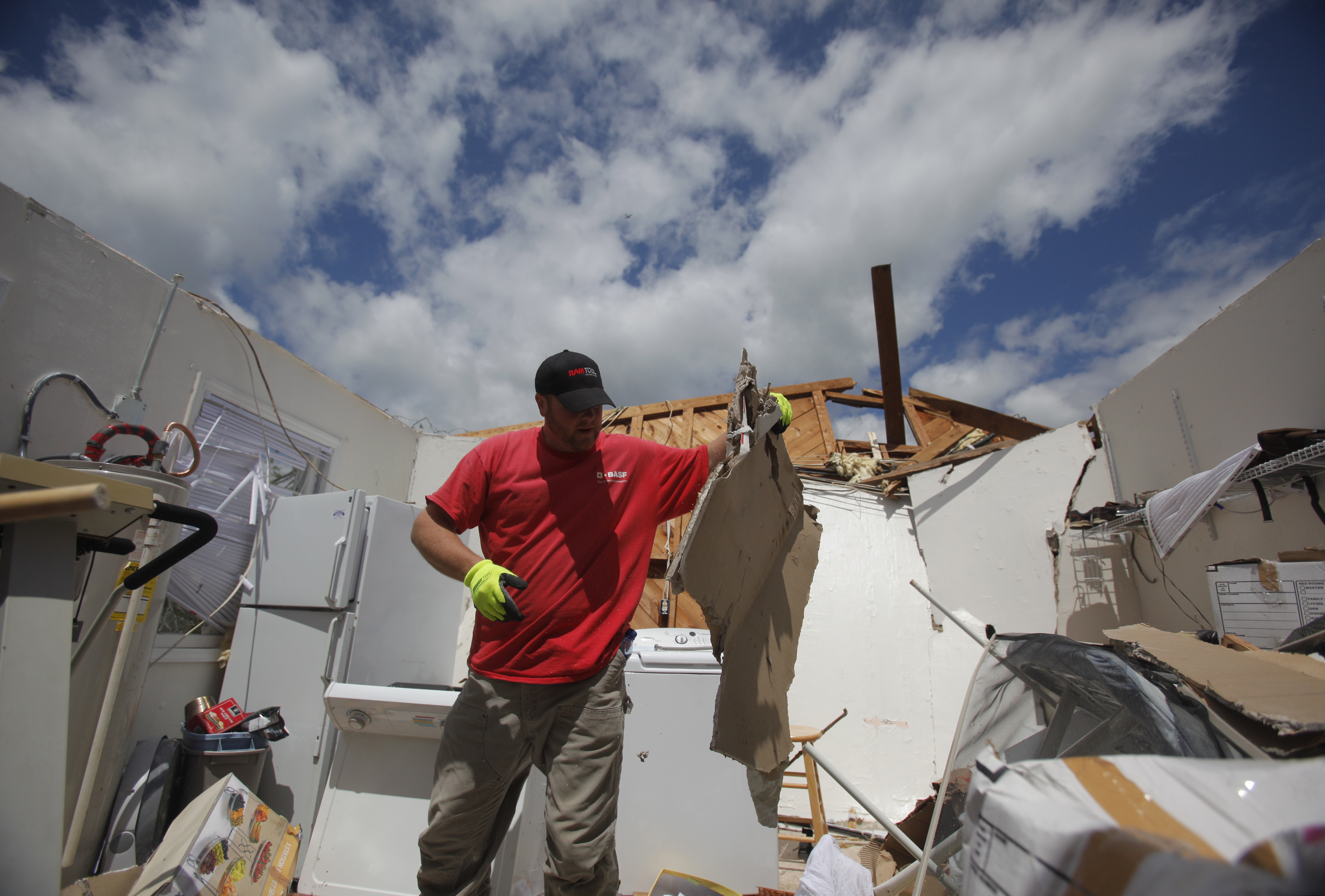 Michael Lockwood {CQ} moves some debris to clear a path through his parents' home in Ringgold, Ga., on Thursday. The neighborhood along Cherokee Valley Rd. in Ringgold, Ga., was laid to waste by a tornado Wednesday night.