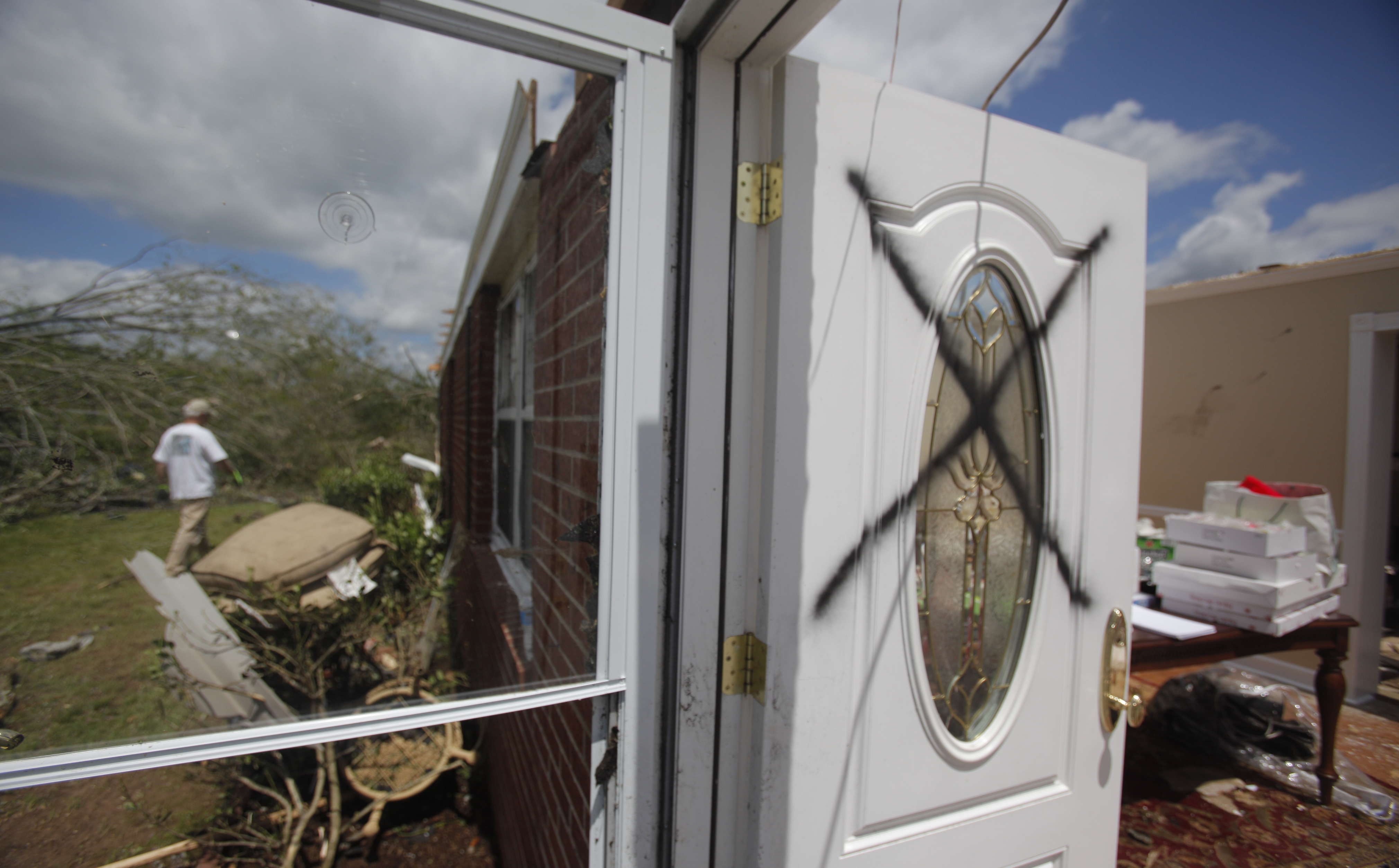 A spray painted X marks the back door of the Vaughn household on Thursday. The couple were home when a tornado ripped the roof off the single story home. The neighborhood along Cherokee Valley Rd. in Ringgold, Ga., was laid to waste by a tornado Wednesday night.