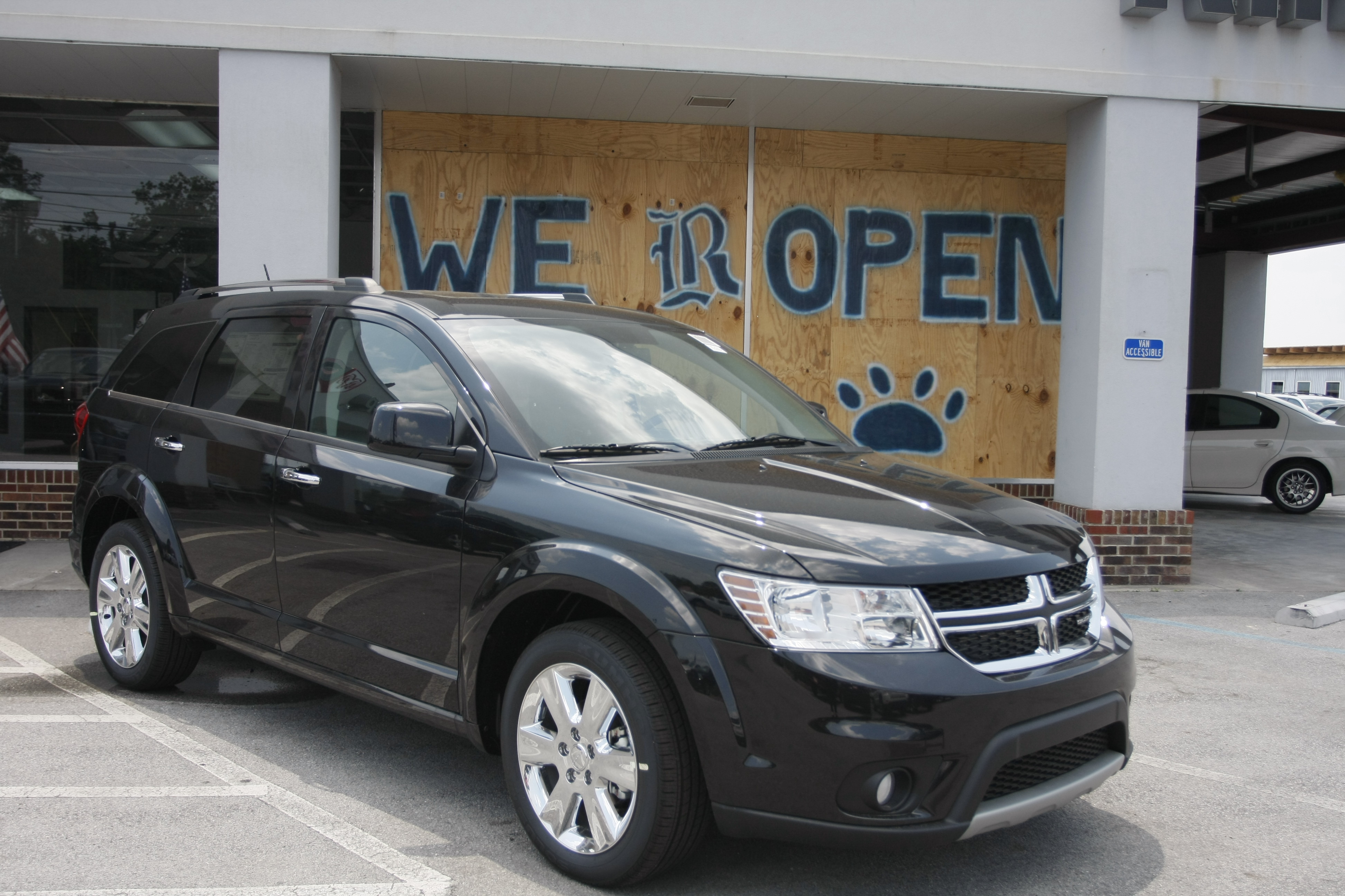 Staff Photo by Allison Carter/Chattanooga Times Free Press - May 31, 2011 - A painted sign outside of Ringgold Chrysler Dodge-Jeep states that the business is open for business. The business received damage from the tornado that went through Ringgold, Ga. in April.