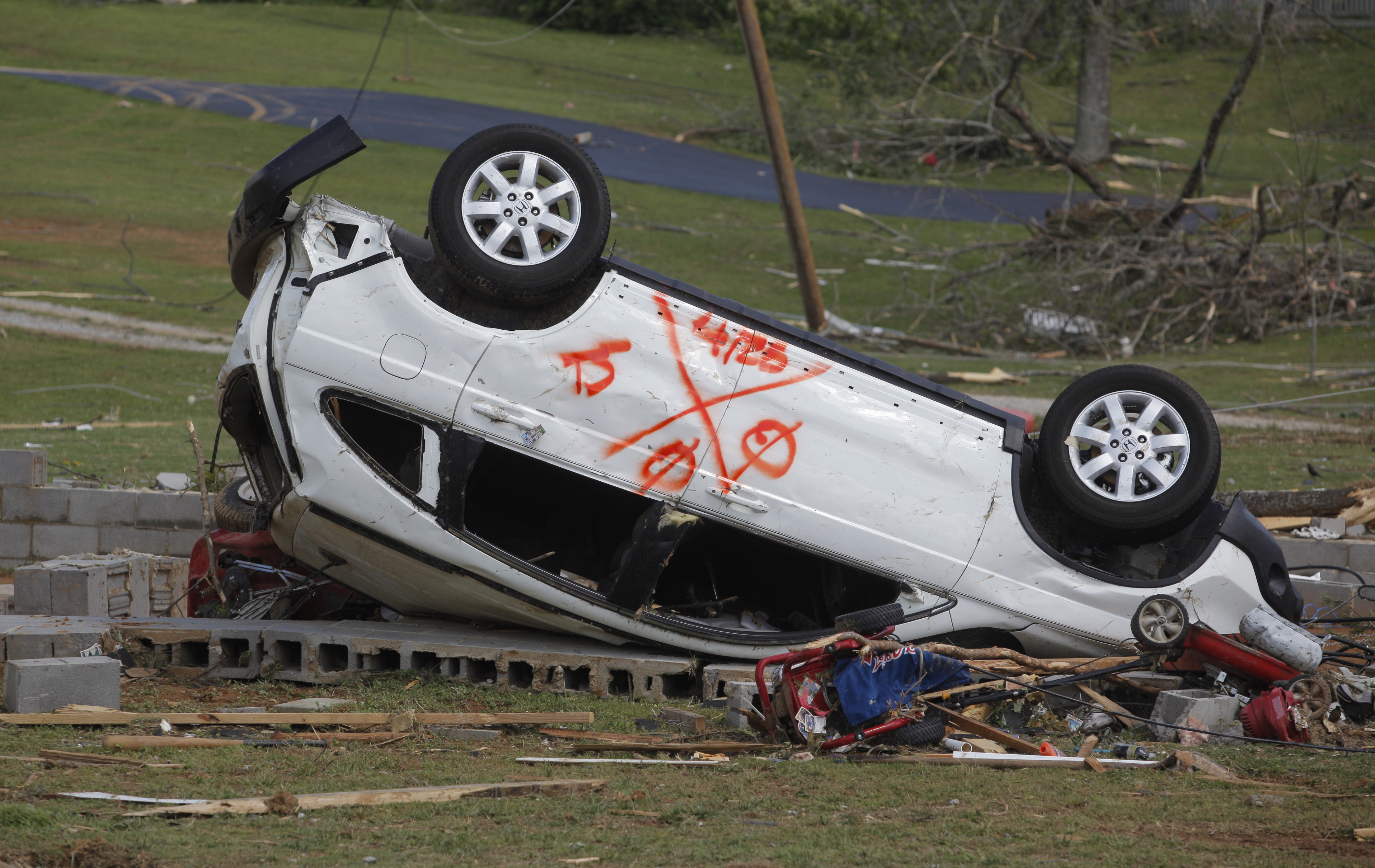 An overturned SUV bears the spray paint markings of a search-and-rescue team on Thursday. The neighborhood along Cherokee Valley Rd. in Ringgold, Ga., was laid to waste by a tornado Wednesday night.