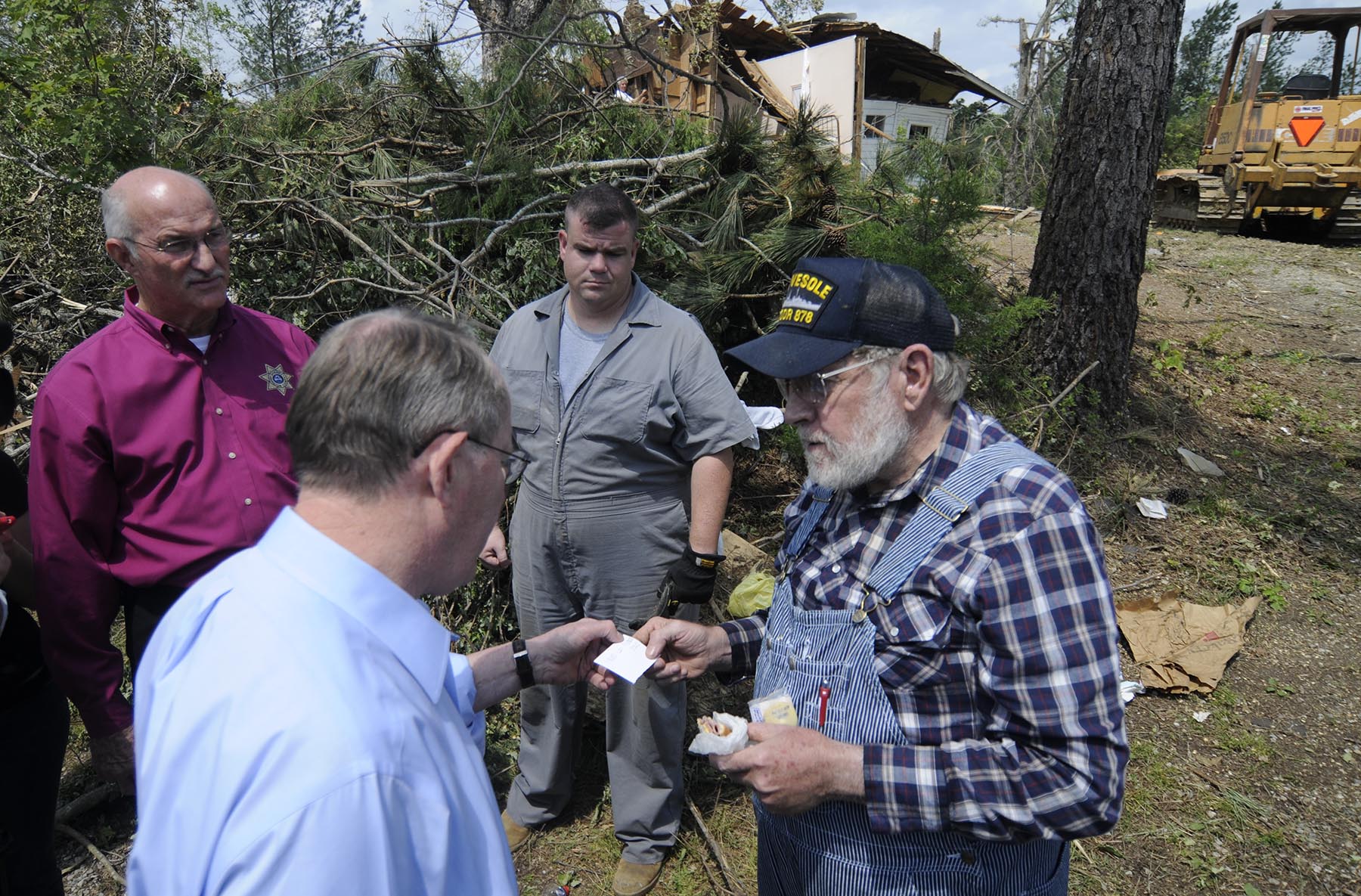 May 2, 2011-- Sen. Lamar Alexander, R-Tenn., second from left, talks with Arthur Bates, right, while touring tornado damaged areas Monday afternoon in Apison, Tn., as Sheriff Jim Hammond, left, looks on. An EF-4 tornado hit Apison last Wednesday and severely damaged Bates' home.