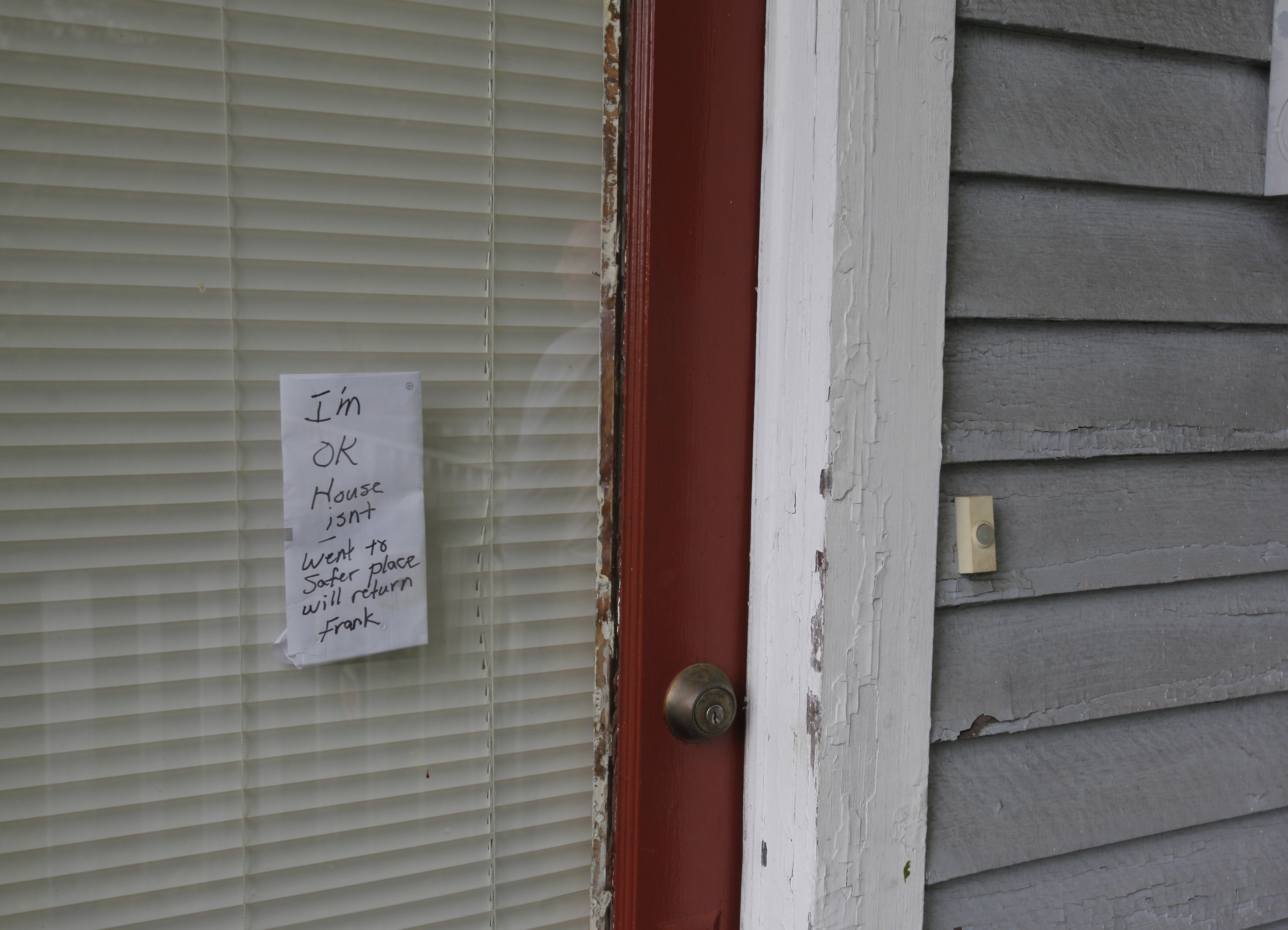 A note on the door of Frank Price's {CQ} home reads