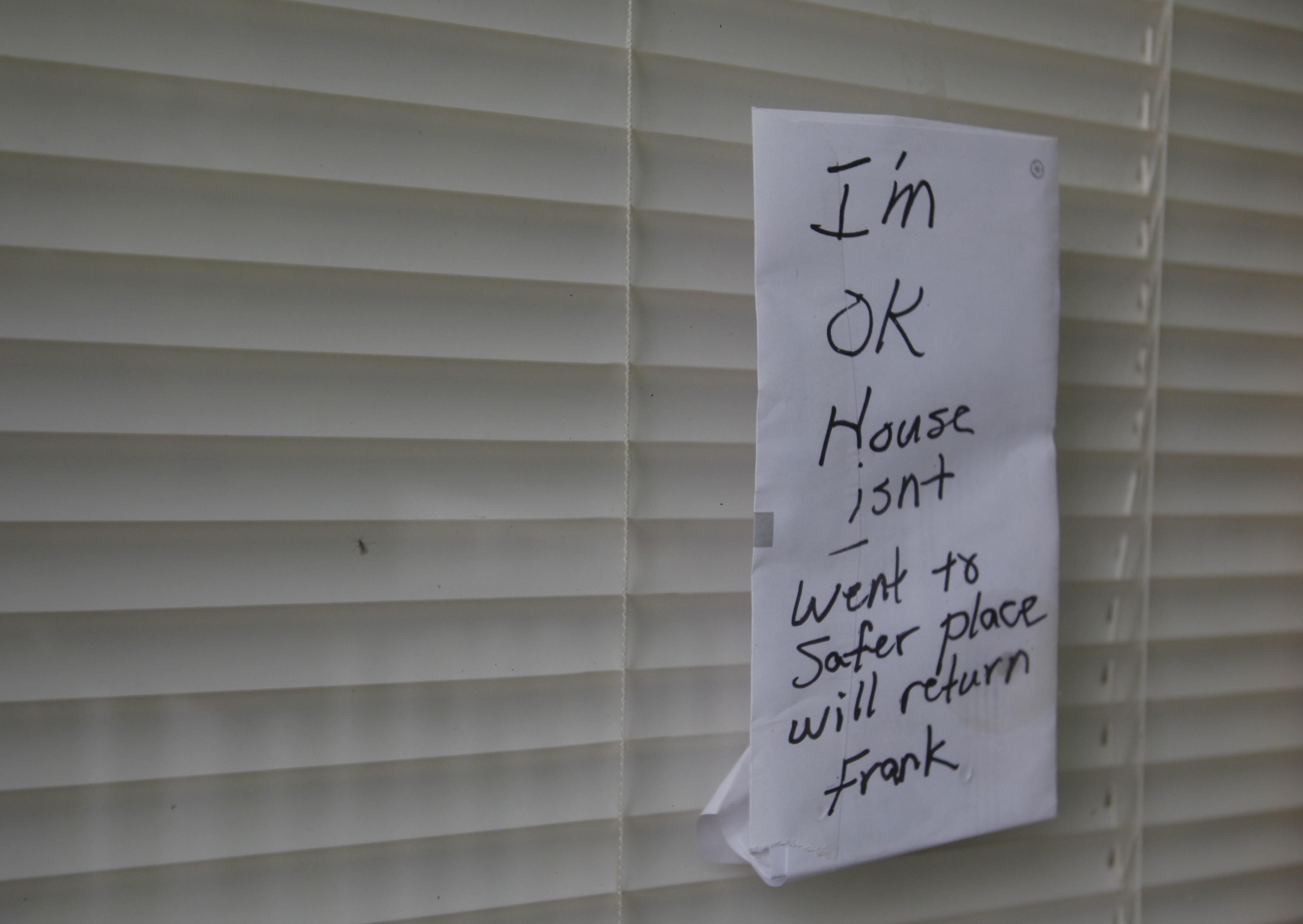 A note on the door of Frank Price's {CQ} home reads
