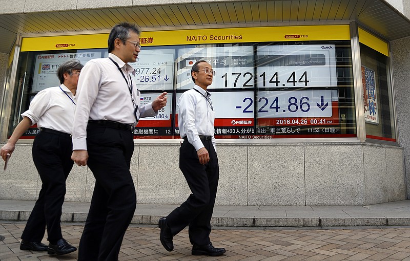 
              People walk past the electronic board of a securities firm in Tokyo, Tuesday, April 26, 2016. Asian stock markets fell Tuesday ahead of U.S. Federal Reserve and Bank of Japan policy meetings, as commodity prices ran out of steam, dragging on big miners. (AP Photo/Shizuo Kambayashi)
            