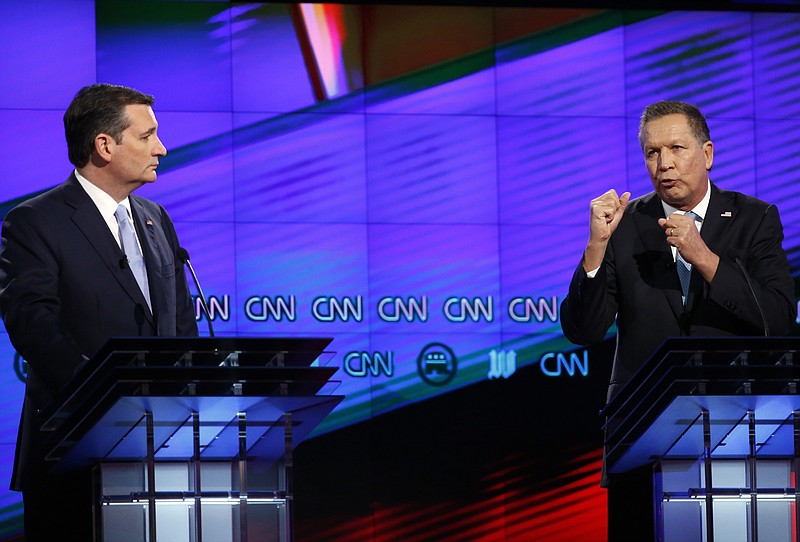 In this March 10, 2016, file photo, Republican presidential candidate Ohio Gov. John Kasich, right, speaks as Republican presidential candidate, Sen. Ted Cruz, R-Texas, listens, during a Republican presidential debate sponsored by CNN, Salem Media Group and the Washington Times at the University of Miami in Coral Gables, Fla. 