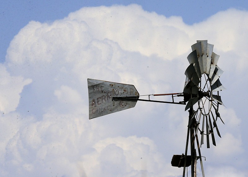 
              Storm clouds build up behind a windmill near Ellsworth, Kan., Tuesday, April 26, 2016. The plains are bracing for a possible severe weather outbreak. (AP Photo/Orlin Wagner)
            