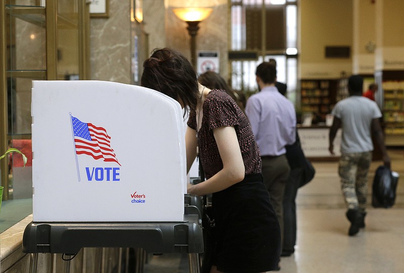 People cast their votes at a polling station inside the Enoch Pratt Free Library's central library branch in Baltimore, Tuesday, April 26, 2016. Maryland voters have many choices and deeper impact than in recent elections as they make their choices about who should run for president and pick candidates for an open U.S. Senate seat.