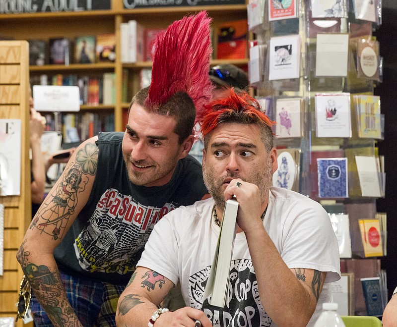 
              NOFX singer “Fat Mike” Burkett, right, poses with a fan at a book signing in Nashville, Tenn., on Tuesday, April 26, 2016. The punk band is exchanging grimy music venues for highbrow bookstores while promoting their joint autobiography “NOFX: The Hepatitis Bathtub and Other Stories.” (AP Photo/Erik Schelzig)
            