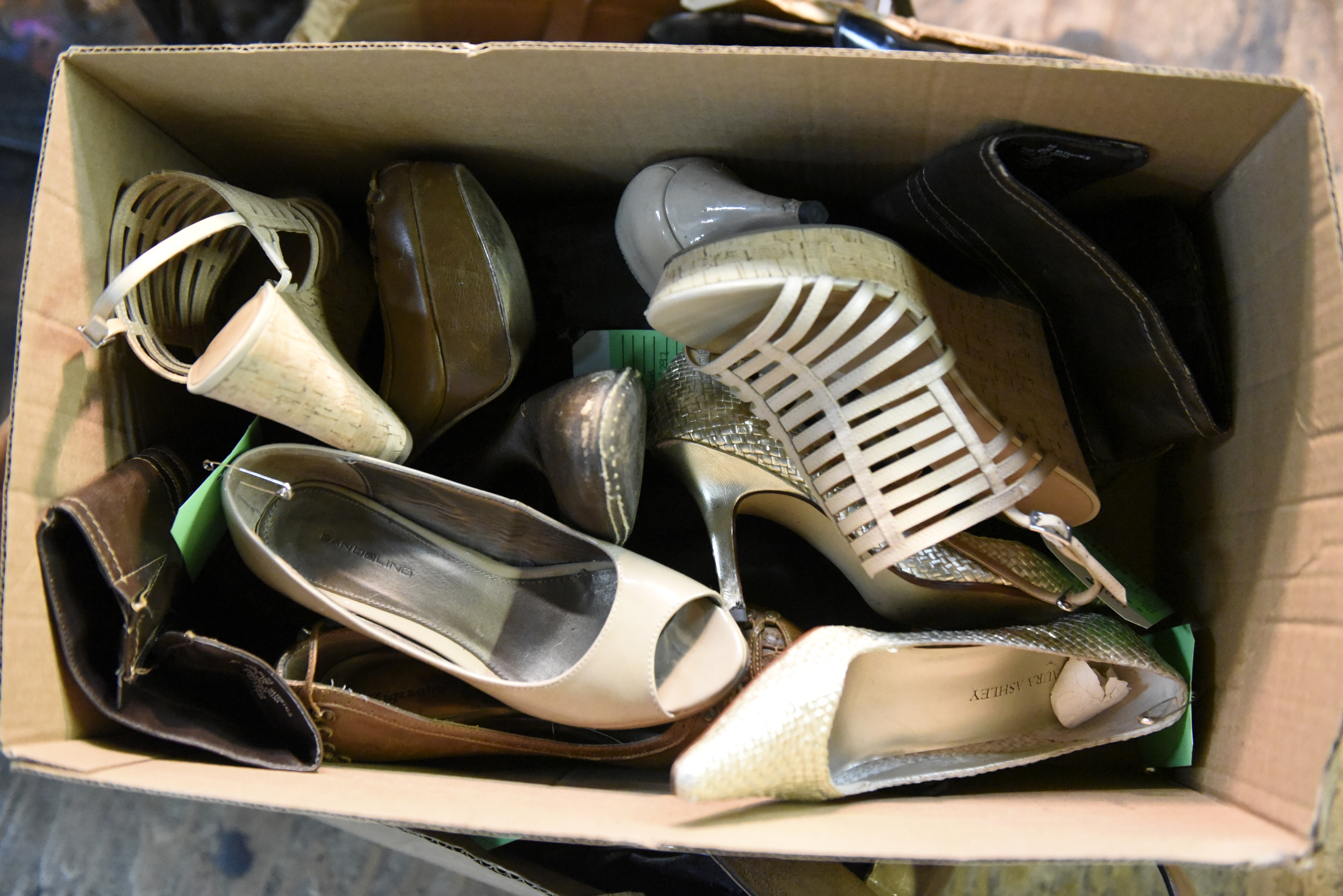 A box of shoes awaiting repairs is seen at the Kenton Shoe Shop, located at the corner of Broad and Eighth Streets Wednesday, Apr. 27, 2016, in Chattanooga, Tenn. A new building owner is remodeling, and Reginald Cousin, age 73, is closing his shop, the last shoe repair business in the downtown area.