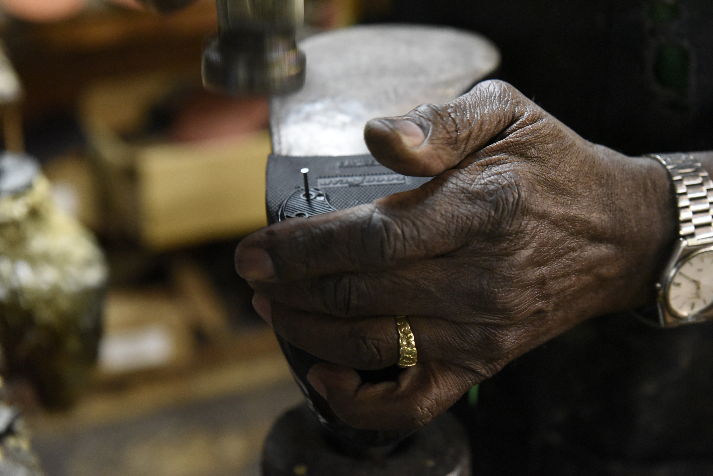 Reginald Cousin works in his shoe repair business, Kenton Shoe Shop, located at the corner of Broad and Eighth Streets Wednesday, Apr. 27, 2016, in Chattanooga, Tenn. A new building owner is remodeling, and Cousin, age 73, is closing his shop, the last shoe repair business in the downtown area.