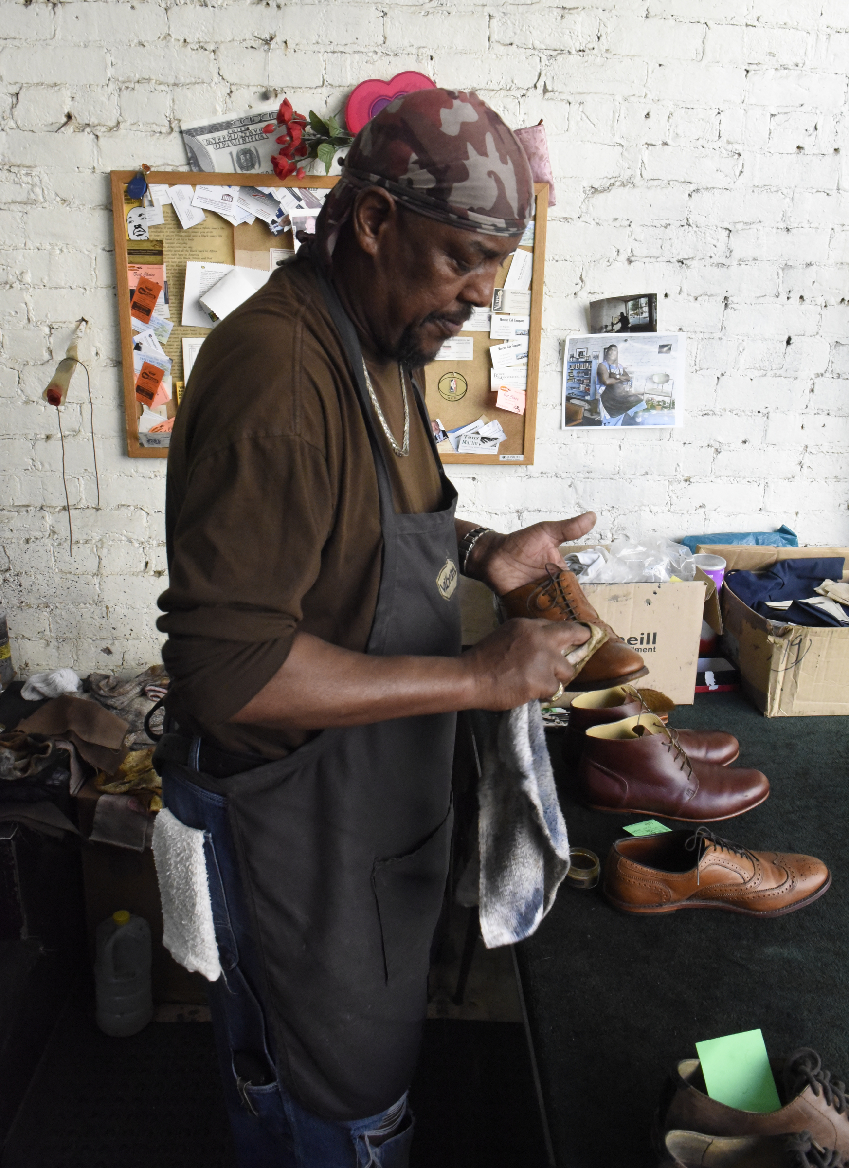 Arthur Ballinger, also known as "Dr. Shine", polishes shoes at Kenton Shoe Shop, located at the corner of Broad and Eighth Streets Wednesday, Apr. 27, 2016, in Chattanooga, Tenn. Ballinger hopes to keep shining shoes downtown after Reginald Cousin closes the shoe shop.