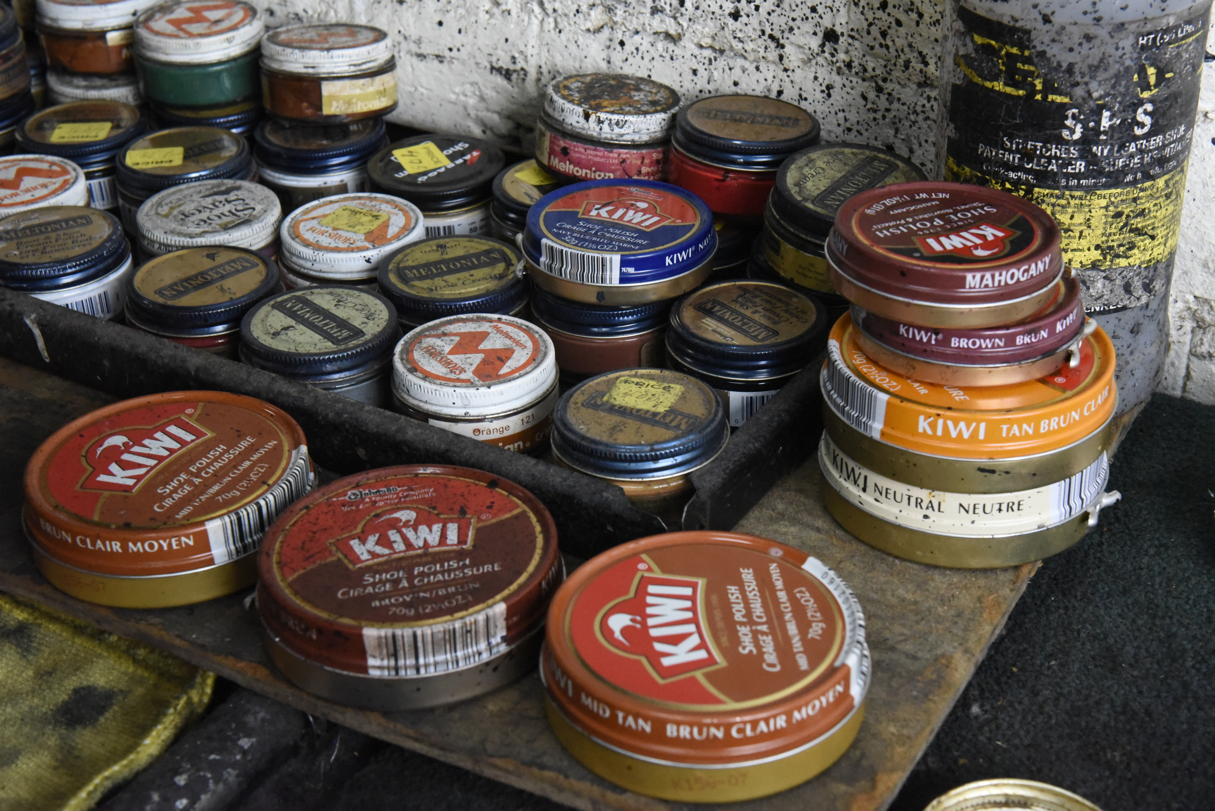 Arthur Ballinger, also known as "Dr. Shine", keeps a number of cans of shoe polish at his stand inside the Kenton Shoe Shop, located at the corner of Broad and Eighth Streets Wednesday, Apr. 27, 2016, in Chattanooga, Tenn. Ballinger hopes to keep shining shoes downtown after Reginald Cousin closes the shoe shop.