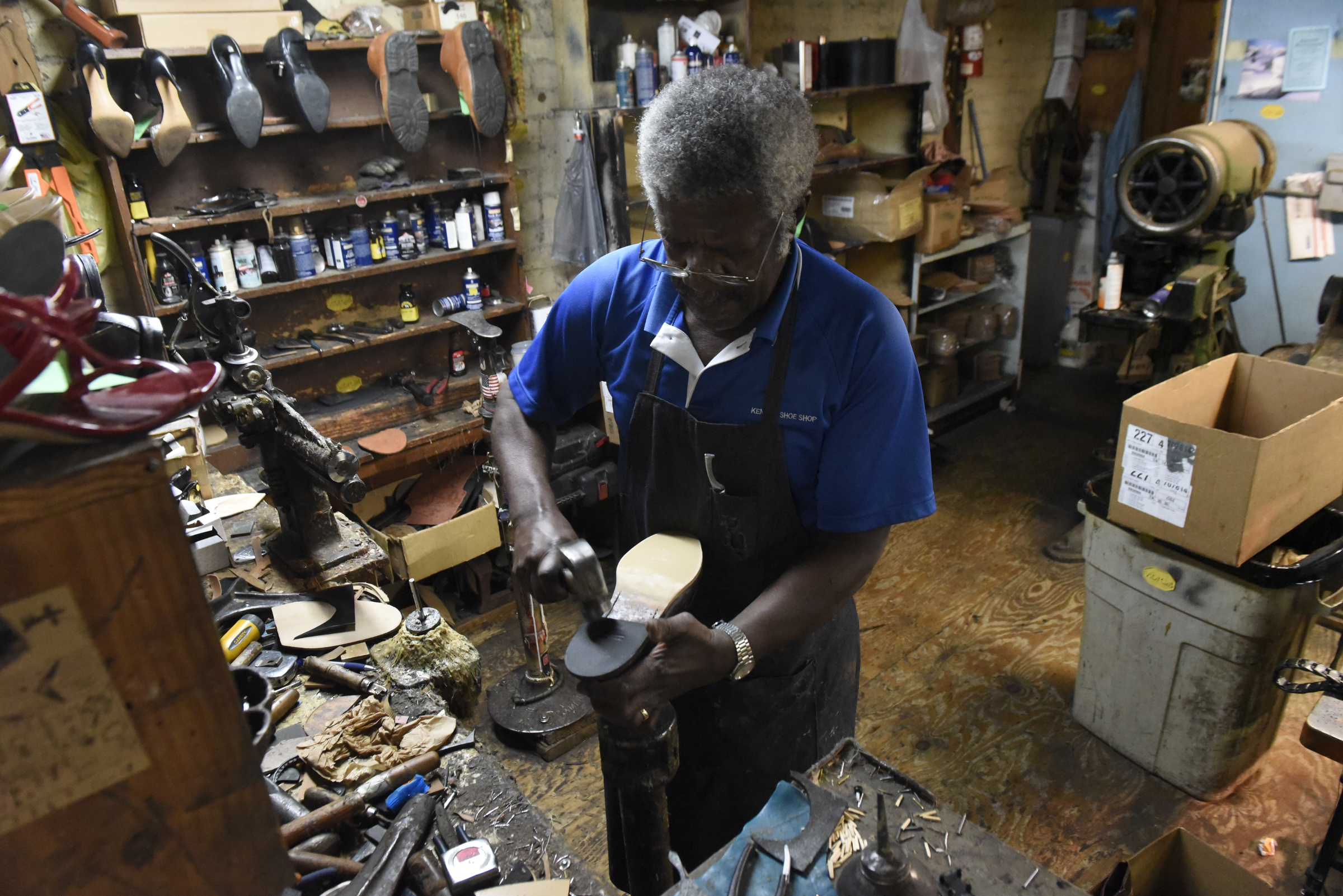 Reginald Cousin works in his shoe repair business, Kenton Shoe Shop, located at the corner of Broad and Eighth Streets Wednesday, Apr. 27, 2016, in Chattanooga, Tenn. A new building owner is remodeling, and Cousin, age 73, is closing his shop, the last shoe repair business in the downtown area.