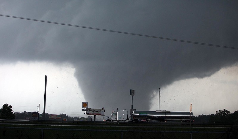 
              FILE - In this April 27, 2011, file photo a deadly tornado moves through Tuscaloosa, Ala. On April 27, 2011, a series of tornadoes killed hundreds of people, injured thousands and reduced countless buildings to rubble across a swath of the U.S. More than 120 tornadoes were reported that day - one of the deadliest outbreaks in the nation's history. (Dusty Compton/The Tuscaloosa News, via AP, File)  MANDATORY CREDIT
            