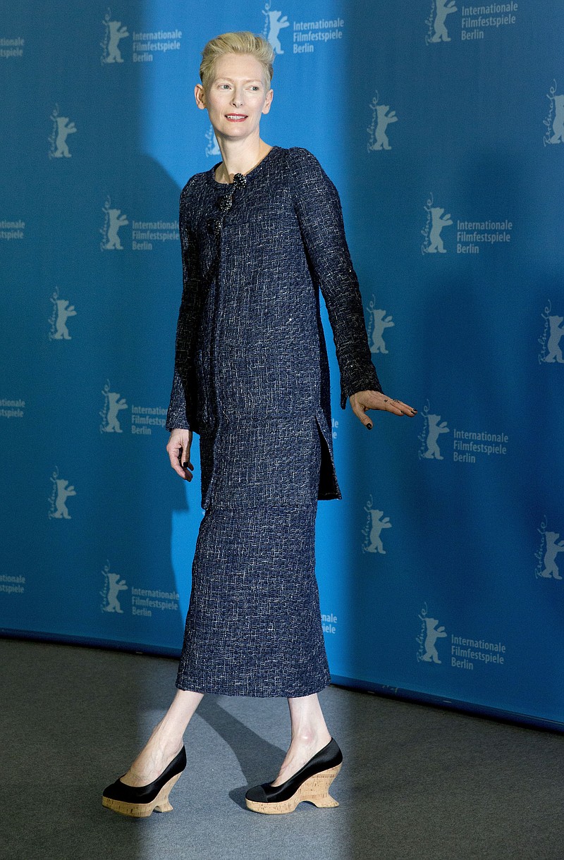 
              FILE - In this Thursday, Feb. 11, 2016 file photo, actress Tilda Swinton leaves after a photo call for the film 'Hail Caesar' at the 2016 Berlinale Film Festival in Berlin, Germany. One of the screenwriters of the film "Doctor Strange" has suggested that the casting of British actress Tilda Swinton as sorcerer the Ancient One, who is a Tibetan male character in the "Doctor Strange" comic books, was partly done to avoid potentially offending China's government and moviegoers, who now represent the world's second-largest annual box office after North America. (AP Photo/Axel Schmidt, File)
            
