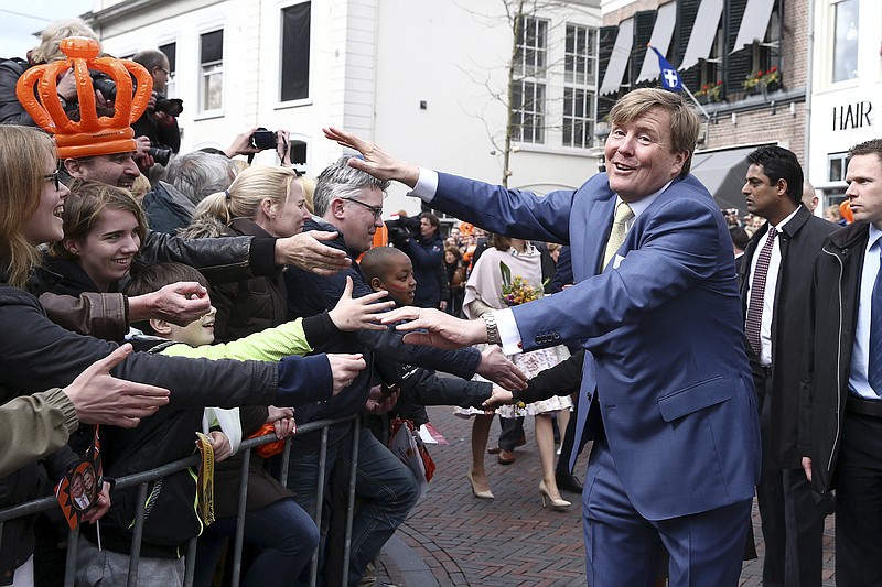 
              King Willem-Alexander greets well-wishers during King's Day celebrations in Zwolle, Netherlands, Wednesday April 27, 2016. The Dutch are marking their king's birthday with an official celebration in the northeastern city of Zwolle and festivals and unofficial garage sales around the nation. (Photo by Andreas Rentz, Pool)
            