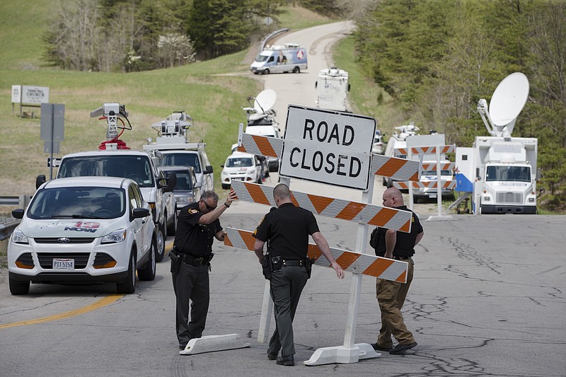In this Friday, April 22, 2016, file photo, authorities set up road blocks at the intersection of Union Hill Road and Route 32 at the perimeter of a crime scene, in Pike County, Ohio.