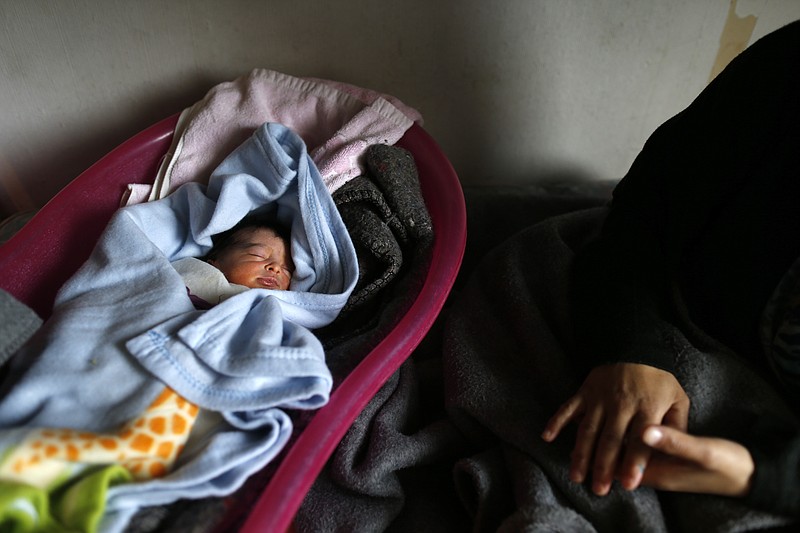 
              A baby named Serbia Merkel Al Mustafa sleeps in the "Krnjaca" collective centre, in Belgrade, Serbia, Thursday, April 28, 2016. Serbia for the country where she was born just a few days ago, Merkel for the German leader where her Syrian refugee parents want to go in their desperate attempt to escape the war and poverty. The Al-Mustafa family is among hundreds of migrants stuck in Serbia after the official closure of the Balkan route for passage.  (AP Photo/Darko Vojinovic)
            