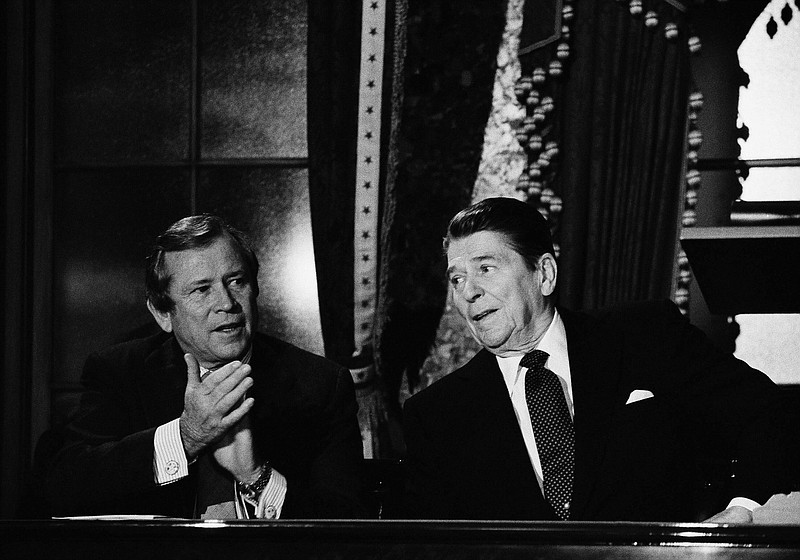 President Ronald Reagan talks to Senate Majority Leader Howard Baker of Tenn. on Wednesday, March 21, 1984 in Washington as he met in the old senate Chamberron Capitol Hill with fellow Republicans to lobby their support of a $150 billion deficit-reduction plan.  (AP Photo/Charles Tasnadi)