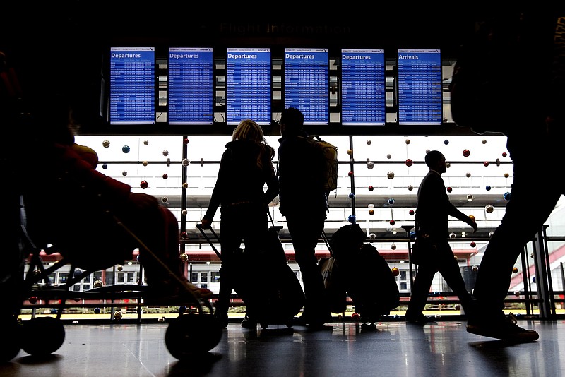 FILE - In this Nov. 29, 2015, file photo, travelers walk to their gates at O'Hare International Airport in Chicago. Airline schedule changes arent always a bad thing. Savvy travelers can use them to their advantage to book the flights they want without paying expensive change fees. (AP Photo/Nam Y. Huh, File)