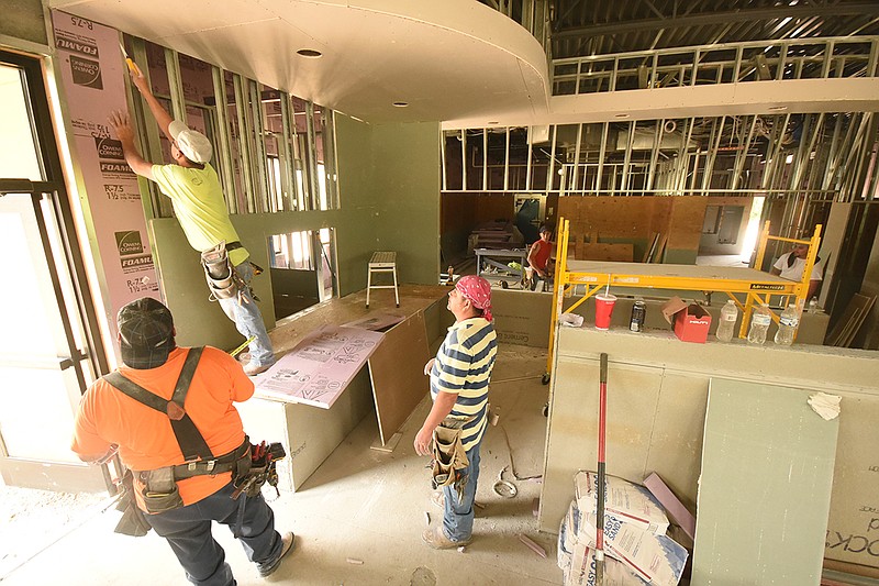 Jackson Specialty employees work to finish the inside of the first Jack's Family Restaurant for the Chattanooga area. The fast food establishment is located in the 3500 block of Cummings Highway. Clockwise from lower left are: Gerardo Jimenez, Omar Rodriguez and Ricardo Alvarez.