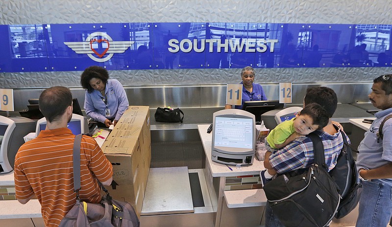 
              FILE - In this June 5, 2014, file photo, travelers check in at a Southwest Airlines ticket counter at Love Field in Dallas. Southwest Airlines caught rivals and Wall Street by surprise when it cut many U.S. fares by $5 each way, applicable to tickets bought within seven days of departure. Meanwhile, Delta Air Lines was busy raising fares on domestic routes by $5 each way. And it did not match Southwest's lower fares where the two carriers compete, a Delta spokesman said Thursday, April 28, 2016. (AP Photo/LM Otero, File)
            