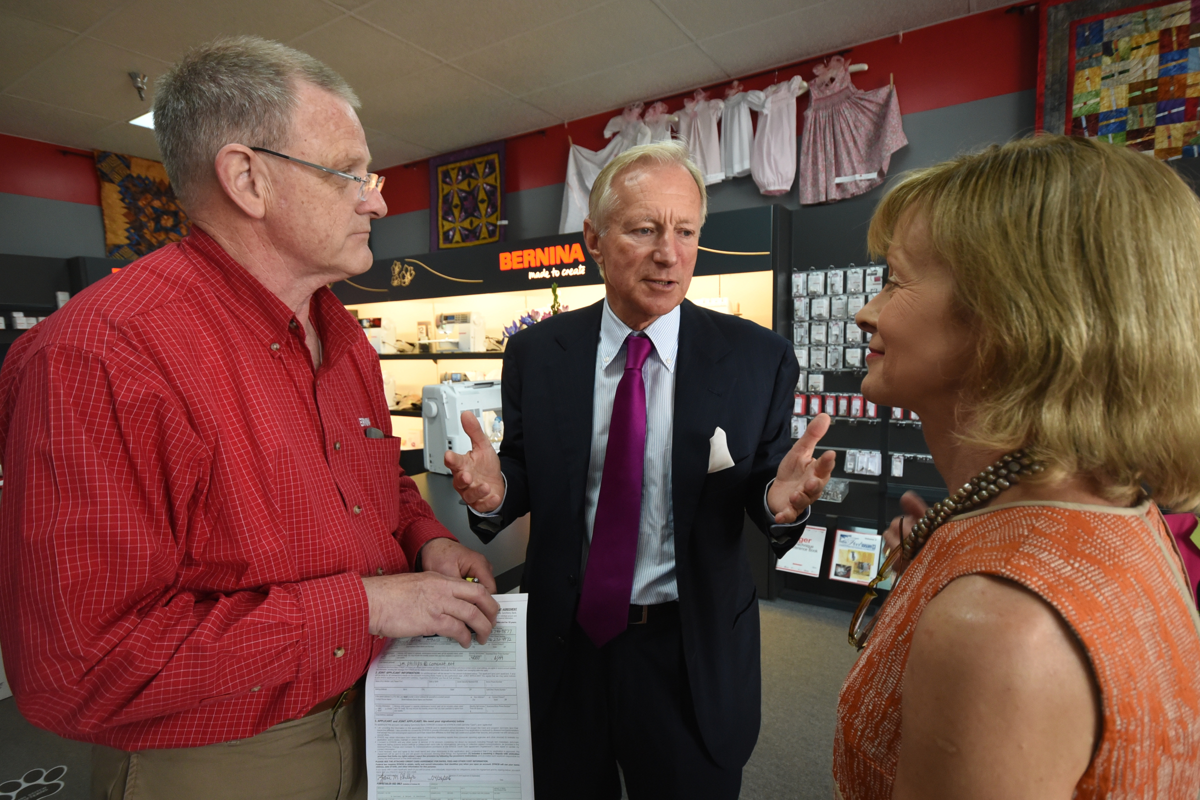 Bernina CEO and owner H.P. Ueltschi, center, talks to Catherine Gross, right, and Bill Klingensmith in the Bernina Sew N Quilt Studio on Shallowford Road.