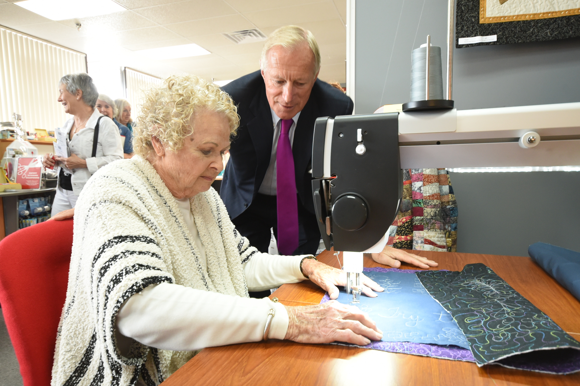 Bernina CEO and owner H.P. Ueltschi watches Gerry Haywood of Chattanooga as she works on a Bernina sewing machine.
