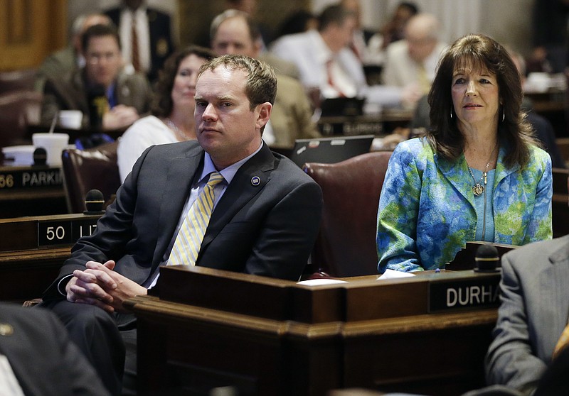 In this April 20, 2016 photo, Rep. Jeremy Durham, R-Franklin, left, listens to a debate in the House of Representatives in Nashville, Tenn. Durham, who is the subject of a sexual harassment investigation by Tennessee's attorney general, has been exiled from the legislative office complex and Capitol for any purpose other than to perform his official duties. At right is Rep. Shelia Butt, R-Columbia. (AP Photo/Mark Humphrey)