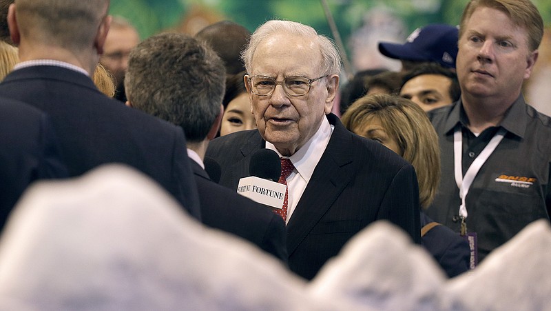 
              Berkshire Hathaway Chairman and CEO Warren Buffett, center, views the BNSF booth as he tours the exhibit floor before presiding over the annual shareholders meeting Saturday, April 30, 2016, in Omaha, Neb. (AP Photo/Charlie Riedel)
            