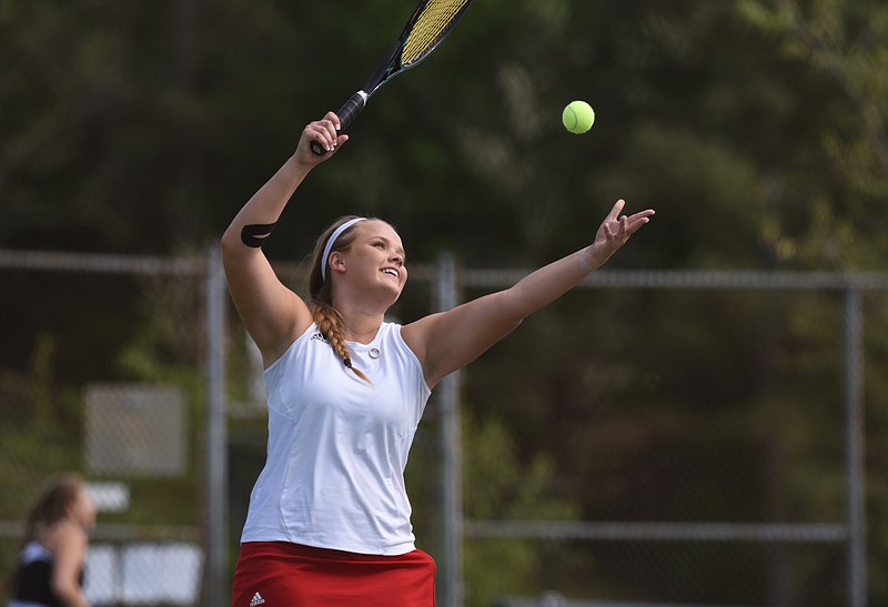 Ooltewah's Sarah Hudson smiles as she serves the ball during Wednesday's District 5-AAA match against East Hamilton. "She always has a smile on her face," said Coach Ken Buchanan. "That's what I like about her."