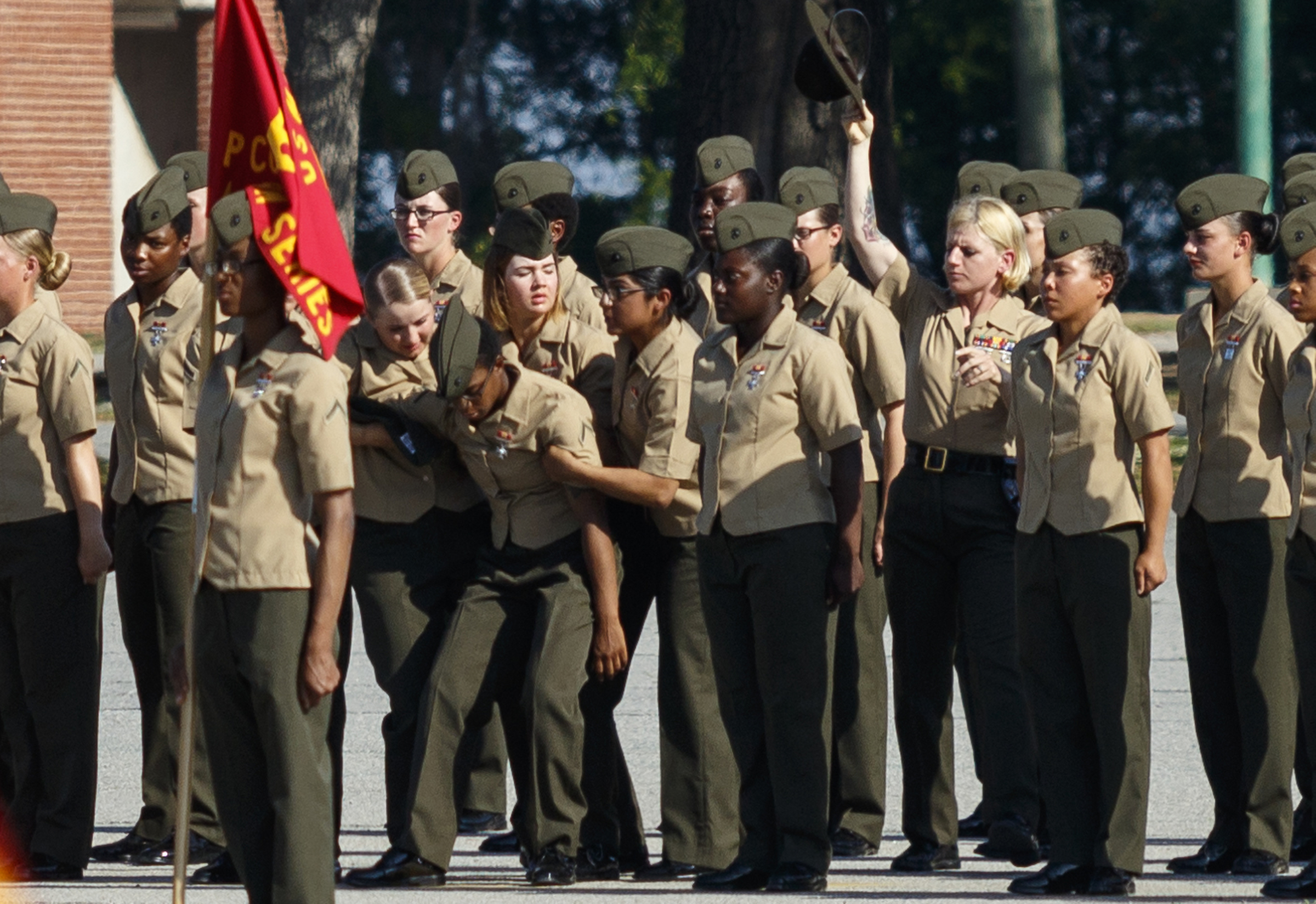 New Marines catch a fellow Marine as she falls out in formation during a graduation ceremony at the Marine Corps Recruit Depot on Friday, April 29, 2016, in Parris Island, South Carolina. 379 new Marines graduated from boot camp Friday.