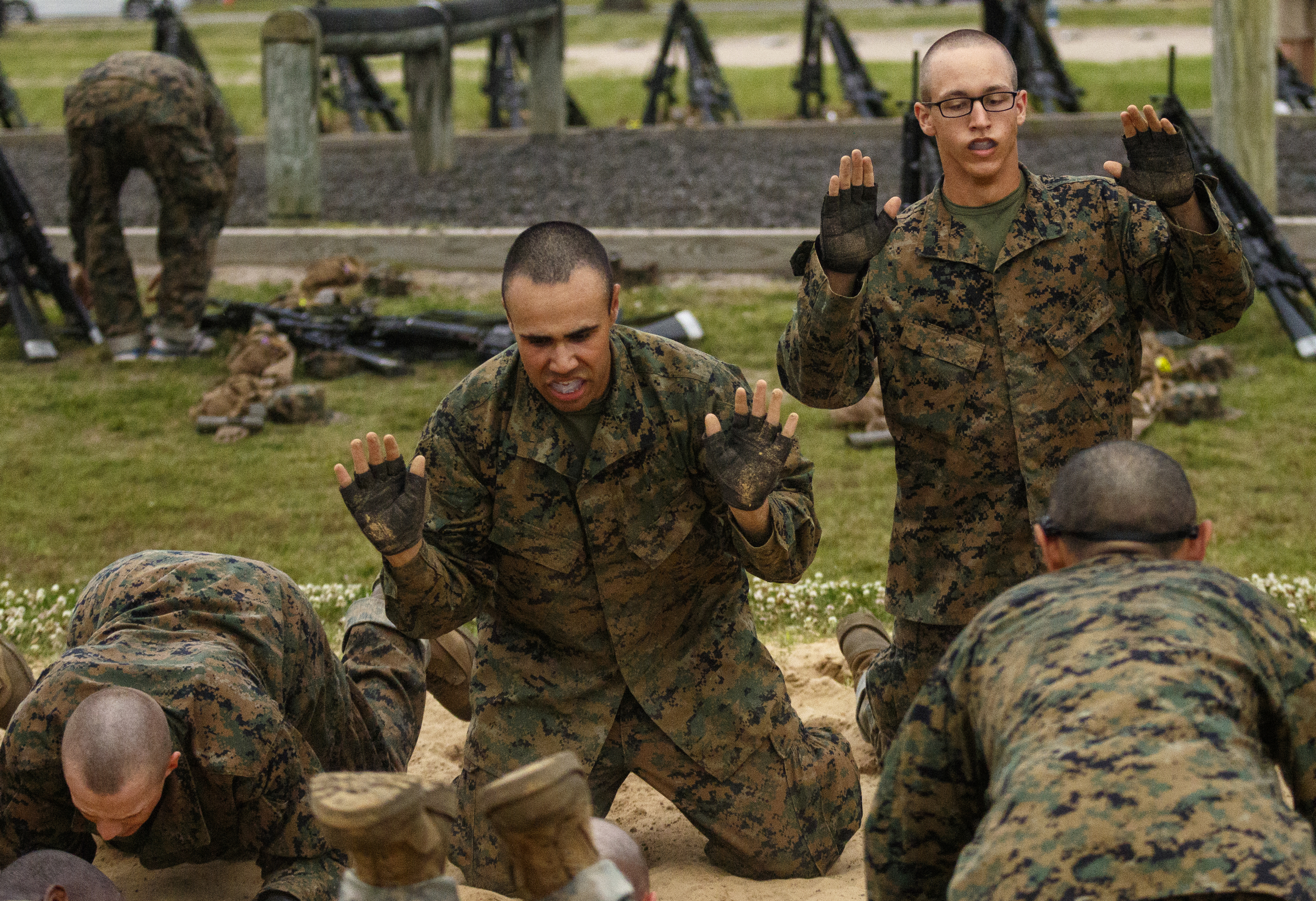 Marine recruits perform safe-fall exercises during morning PT at the Marine Corps Recruit Depot on Thursday, April 28, 2016, in Parris Island, South Carolina.