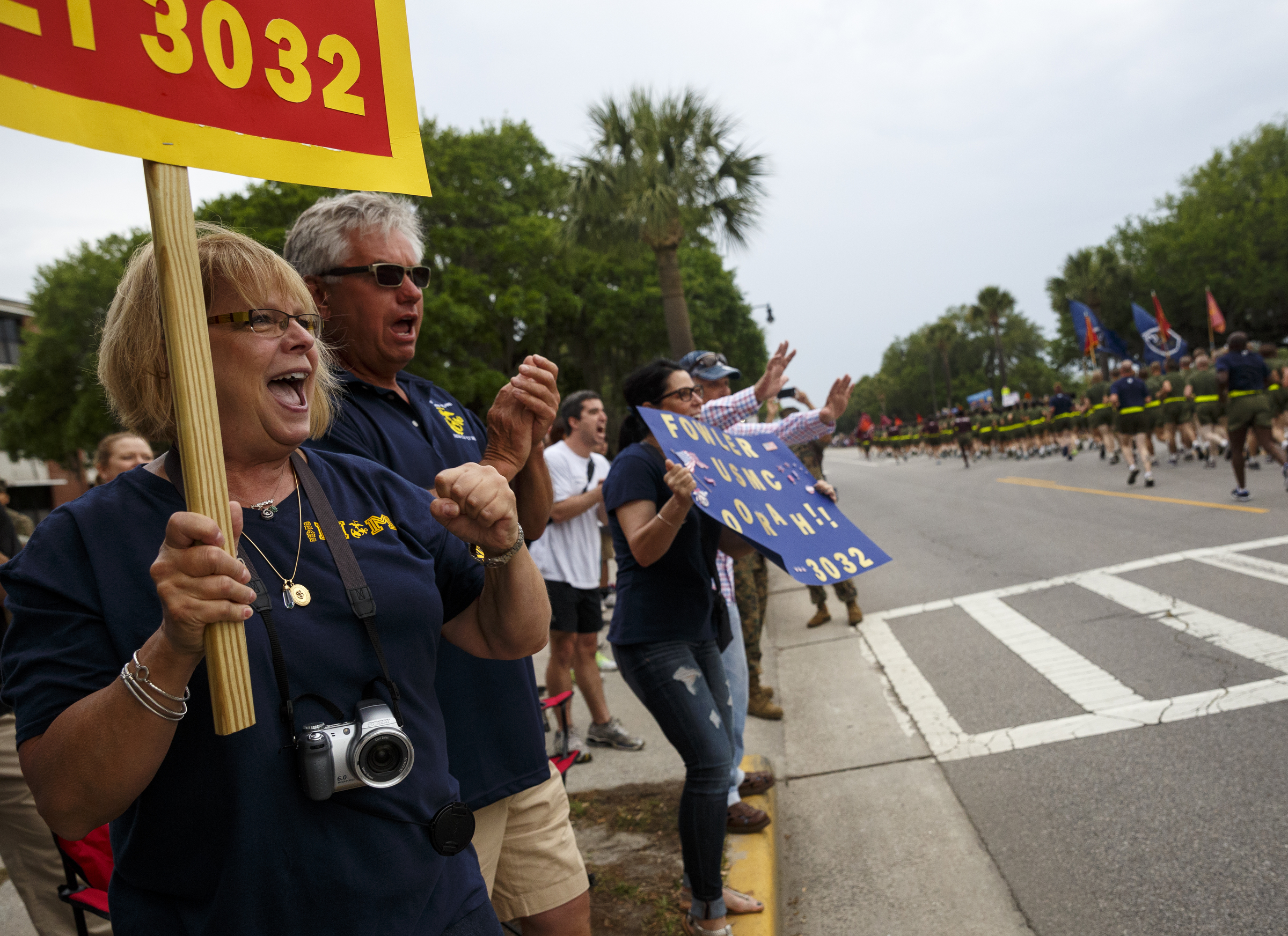 Phylis South, left, and Sam South, from Greenville, South Carolina, cheer for their grandson Ryan Fowler, a graduating Marine, as he runs past with other graduating Marines on family day at the Marine Corps Recruit Depot on Thursday, April 28, 2016, in Parris Island, South Carolina.