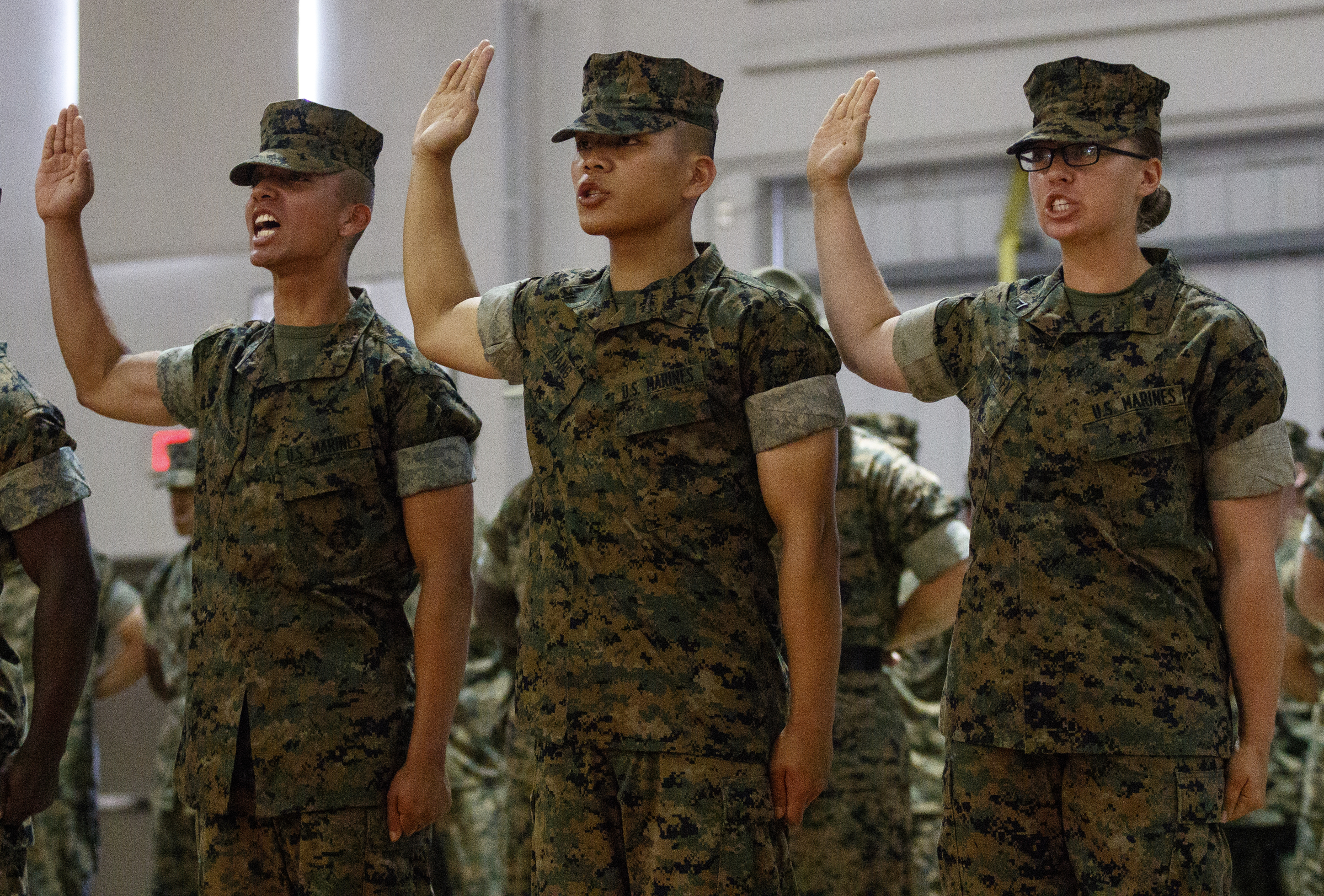New Marines who immigrated to the U.S. raise their hands to take the oath of citizenship in a naturalization ceremony during a family day event the day before graduation at the Marine Corps Recruit Depot on Thursday, April 28, 2016, in Parris Island, South Carolina.