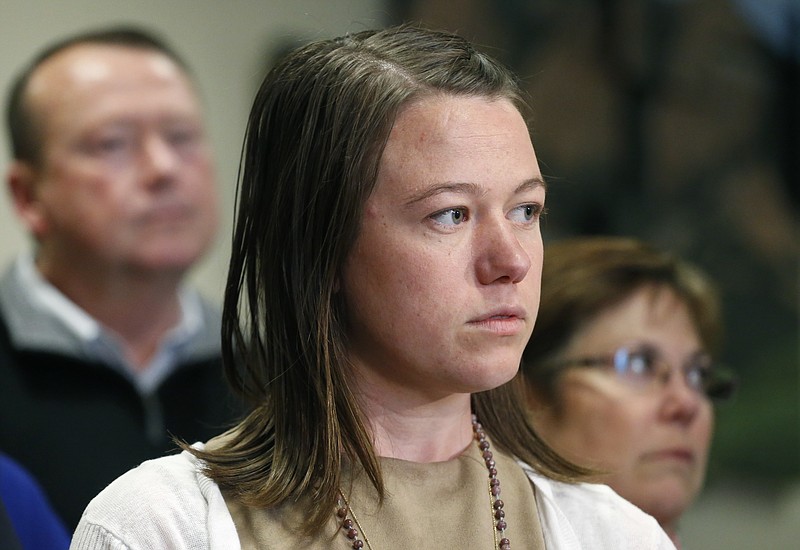 
              Michelle Wilkins, center, stands with her father Mark and mother Wendy, as Wilkins speaks with members of the media following the sentencing hearing for Dynel Lane, who was given 100 years in prison for cutting the nearly 8-month-old fetus from Wilkins's womb in 2015, at the Boulder County Justice Center, in Boulder, Colo., Friday, April 29, 2016. A jury convicted Lane, 36, in February, 2016 of attempting to kill Michelle Wilkins in 2015. Lane also was convicted of assault and unlawful termination of a pregnancy after luring Wilkins with an ad for maternity clothes. (AP Photo/Brennan Linsley)
            