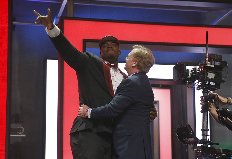 Mississippi State's Chris Jones celebrates with NFL Commissioner Roger Goodell after being selected by the Kansas City Chiefs as the 37th pick in the second round of the 2016 NFL football draft, Friday, April 29, 2016, in Chicago. (AP Photo/Charles Rex Arbogast)