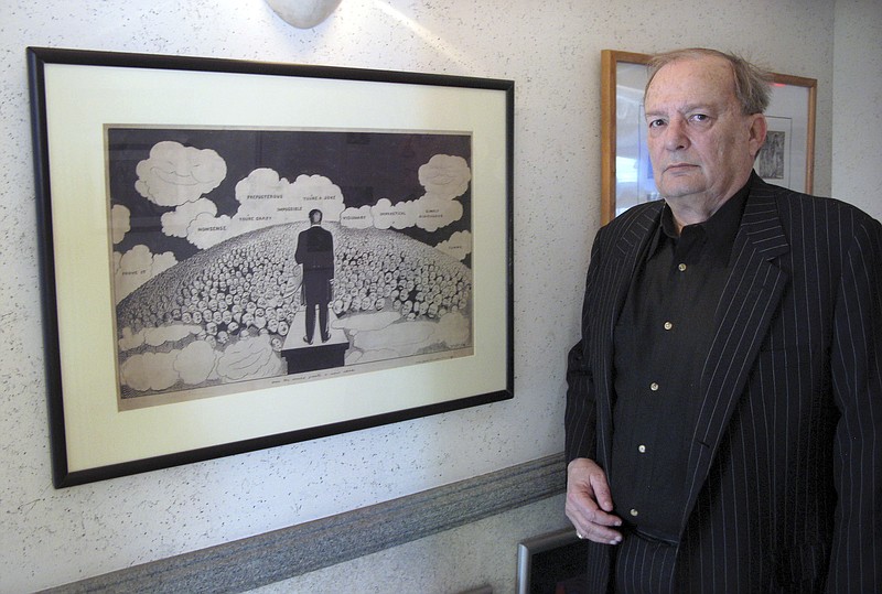 
              In this Friday, April 29, 2016 photo, attorney Bruce Rubenstein, a collector of left-wing political memorabilia, stands in front of a 1920s drawing by political cartoonist Art Young on April 29, 2016 inside his office in Hartford, Conn. Rubenstein is threatening to sue the University of Hartford which plans to sell a political memorabilia collection to which Rubenstein donated hundreds of items. (AP Photo/Pat Eaton-Robb)
            