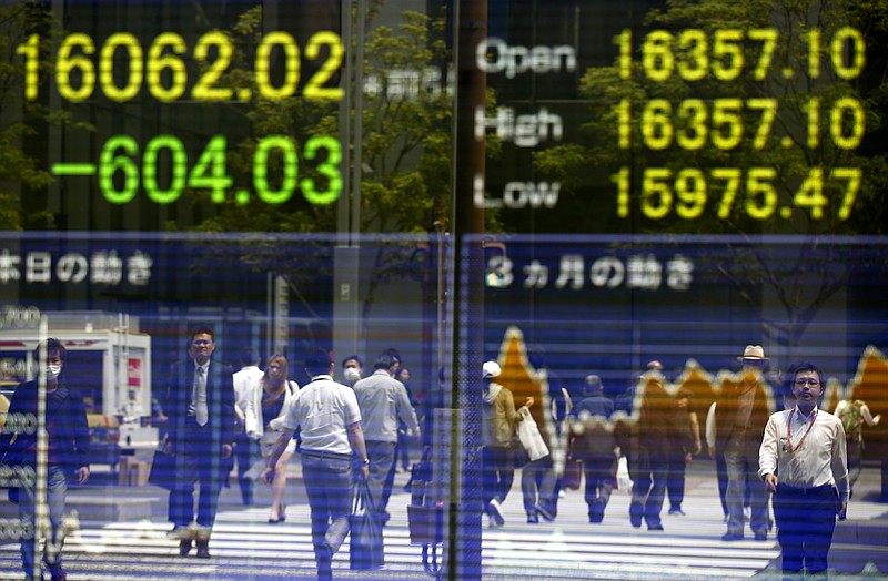 
              People are reflected on the electronic board of a securities firm in Tokyo, Monday, May 2, 2016. Asian stock markets fell Monday as investors displayed their disappointment over the lack of further stimulus from Japan's central bank. The surge in the Japanese yen and a bleak outcome from a monthly factory managers' survey did little to lighten the gloom. (AP Photo/Shizuo Kambayashi)
            