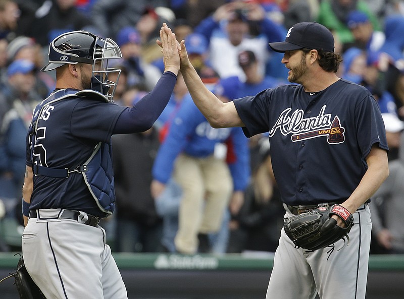 Atlanta Braves relief pitcher Jason Grilli, right, celebrates with catcher Tyler Flowers after they defeated the Chicago Cubs 4-3 in a baseball game, Sunday, May 1, 2016, in Chicago. (AP Photo/Nam Y. Huh)