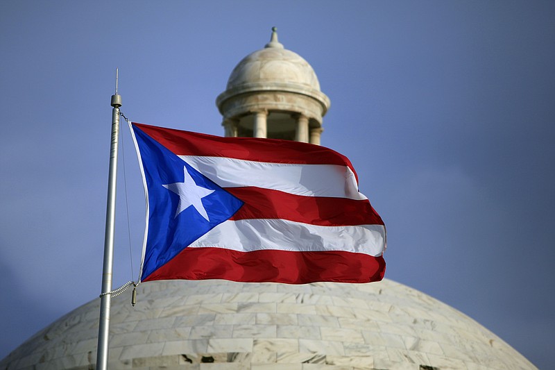 
              FILE - In this Wednesday, July 29, file 2015 photo, the Puerto Rican flag flies in front of Puerto Rico’s Capitol as in San Juan, Puerto Rico. Puerto Rico Gov. Alejandro Javier Garcia Padilla said on Sunday, May 1, 2016, that negotiators for the U.S. territory’s government have failed to reach a last-minute deal to avoid a third default and that he has issued an executive order to withhold payment. (AP Photo/Ricardo Arduengo, File)
            