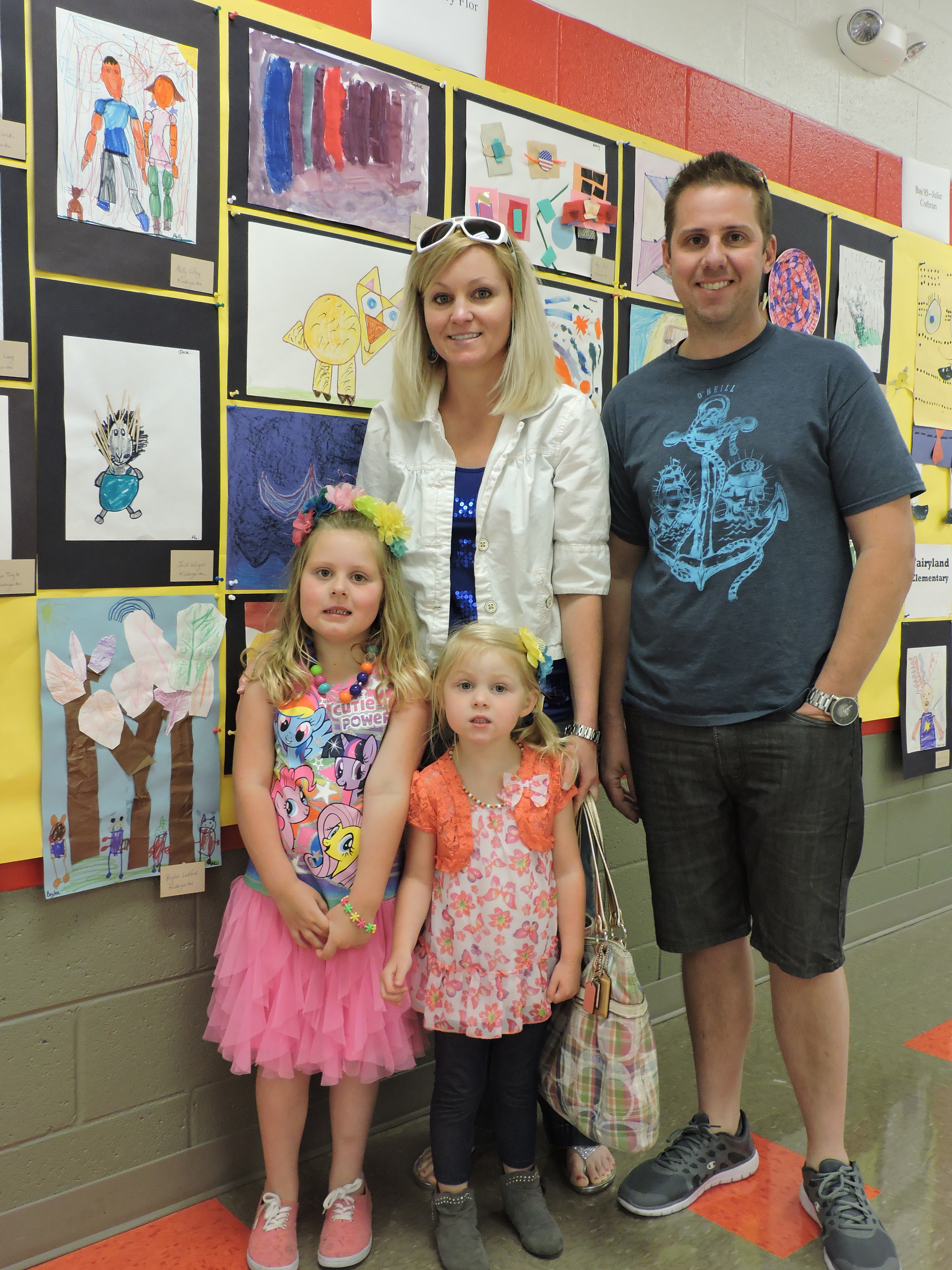 Fairyland Elementary School kindergartner Brylee Ledford, with siblings Kaiden Ledford, Erin Ledford and Aaron Ledford, from left, check out Brylee's work of art on the wall at the Artrageous Antics Art Show at Saddle Ridge School.