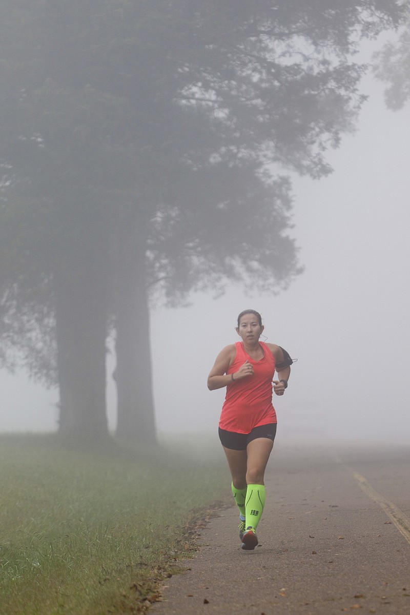 Staff Photo by Dan Henry / The Chattanooga Times Free Press- 10/7/15. Kim Edgeman runs through the fog at Chickamauga Battlefield on Wednesday, October 7, 2015 while training for the upcoming Battlefield Marathon. 